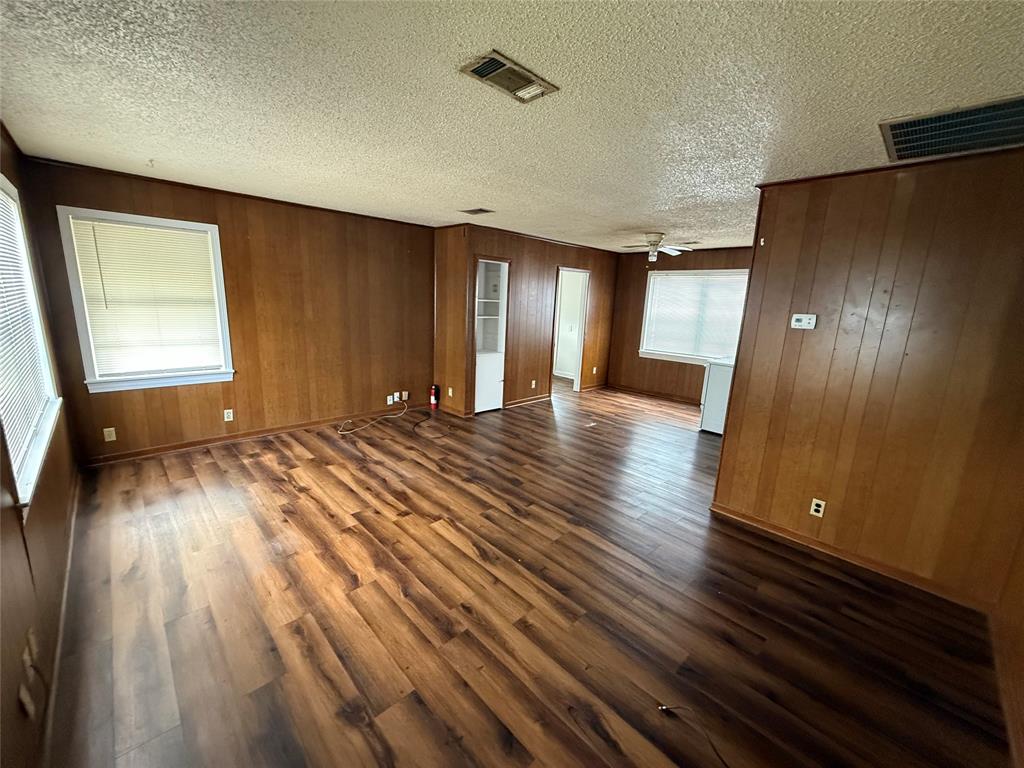 301 Boyd Loop Bonham, TX 75418 - Photo 5 of 11 wooden floor in an empty room with a window