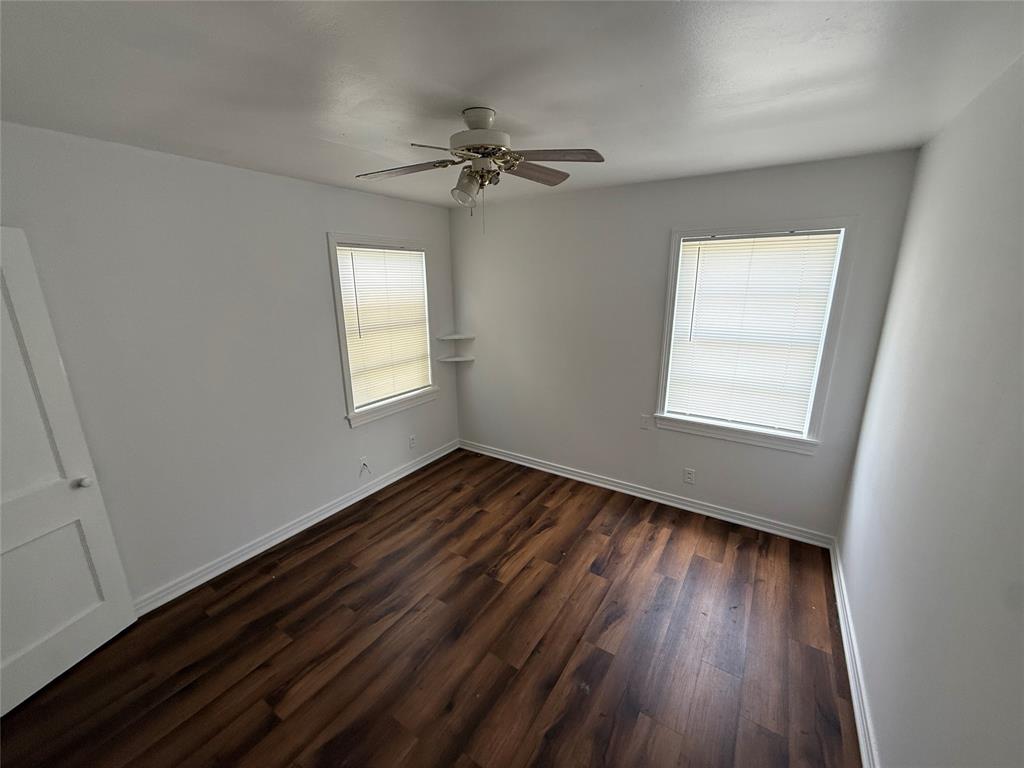 301 Boyd Loop Bonham, TX 75418 - Photo 7 of 11 wooden floor in an empty room with a window