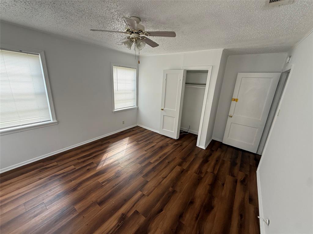 301 Boyd Loop Bonham, TX 75418 - Photo 8 of 11 a view of an empty room with wooden floor and a window