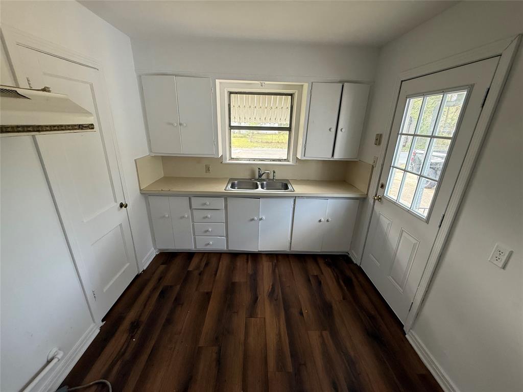 301 Boyd Loop Bonham, TX 75418 - Photo 10 of 11 a kitchen with sink a window and cabinets