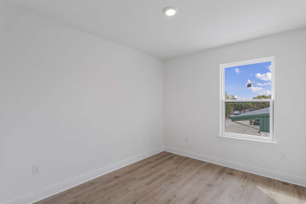 7 Redbird Loop Destin, FL 32541 - Photo 15 of 23 a view of an empty room with wooden floor and a window