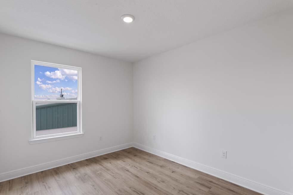 7 Redbird Loop Destin, FL 32541 - Photo 17 of 23 a view of an empty room with wooden floor and a window