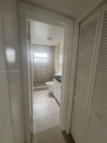 a bathroom with a glass door shower