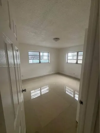 a view of empty room with windows