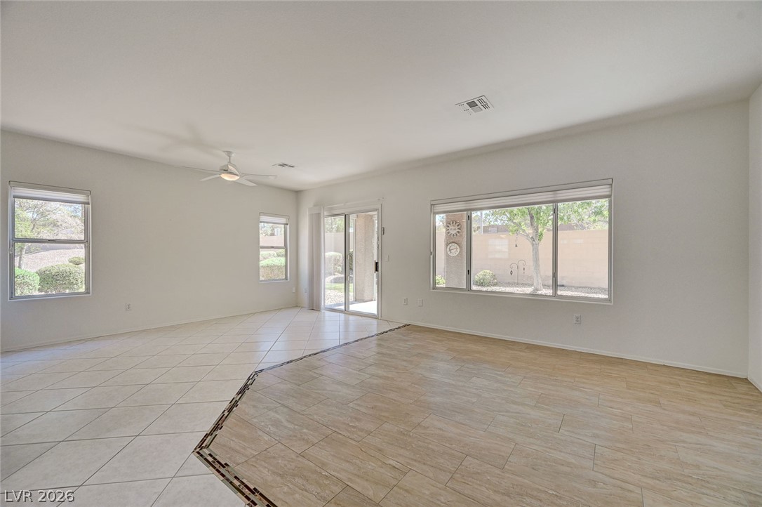 2529 Springville Way Henderson, NV 89052 - Photo 6 of 70 Dual-textured flooring and abundant natural light define this expansive open living space.