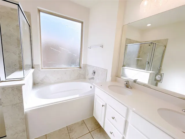 a large white kitchen with wooden floors and view living room