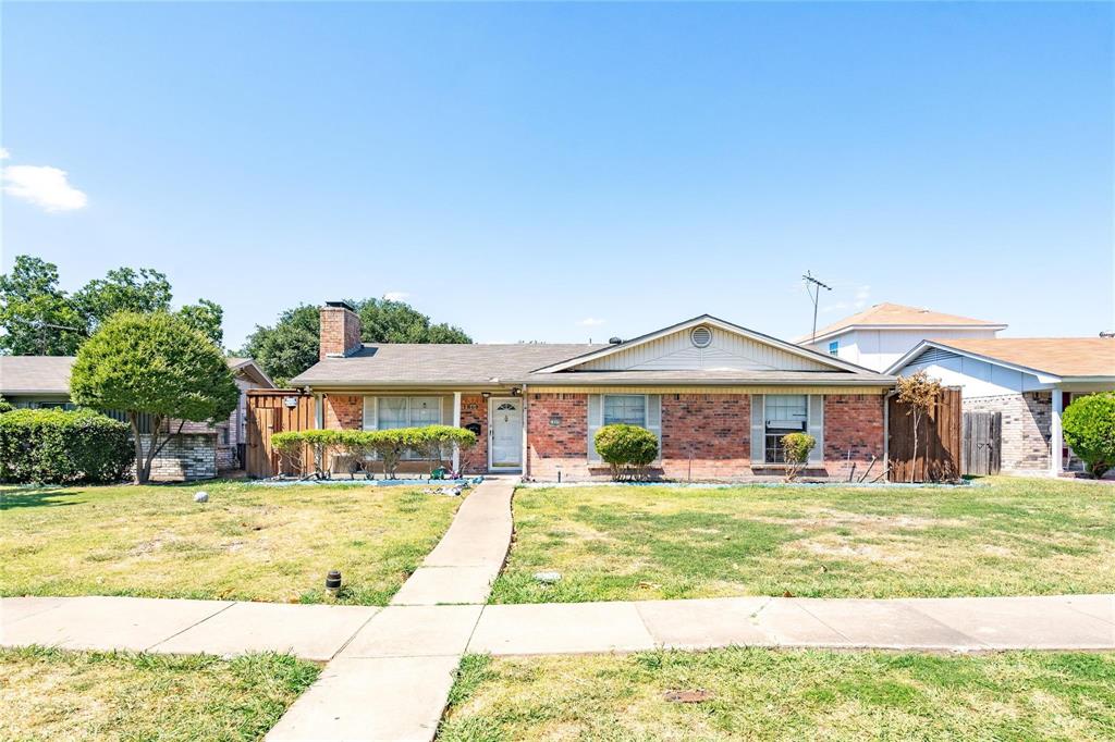 1809 Crockett Street Garland, TX 75042 - Photo 2 of 8 a front view of a house with a yard
