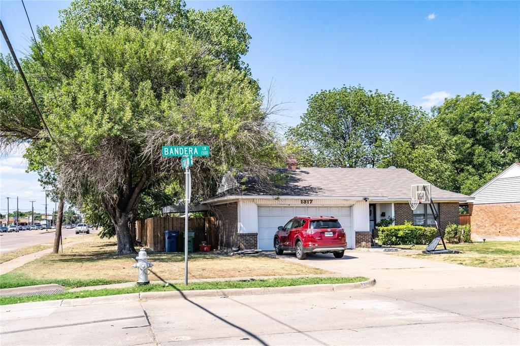 1809 Crockett Street Garland, TX 75042 - Photo 4 of 8 a car parked in front of a houses