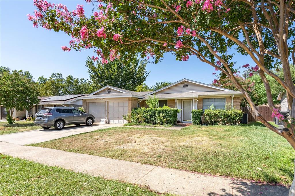 1809 Crockett Street Garland, TX 75042 - Photo 5 of 8 a front view of a house with a yard and garage