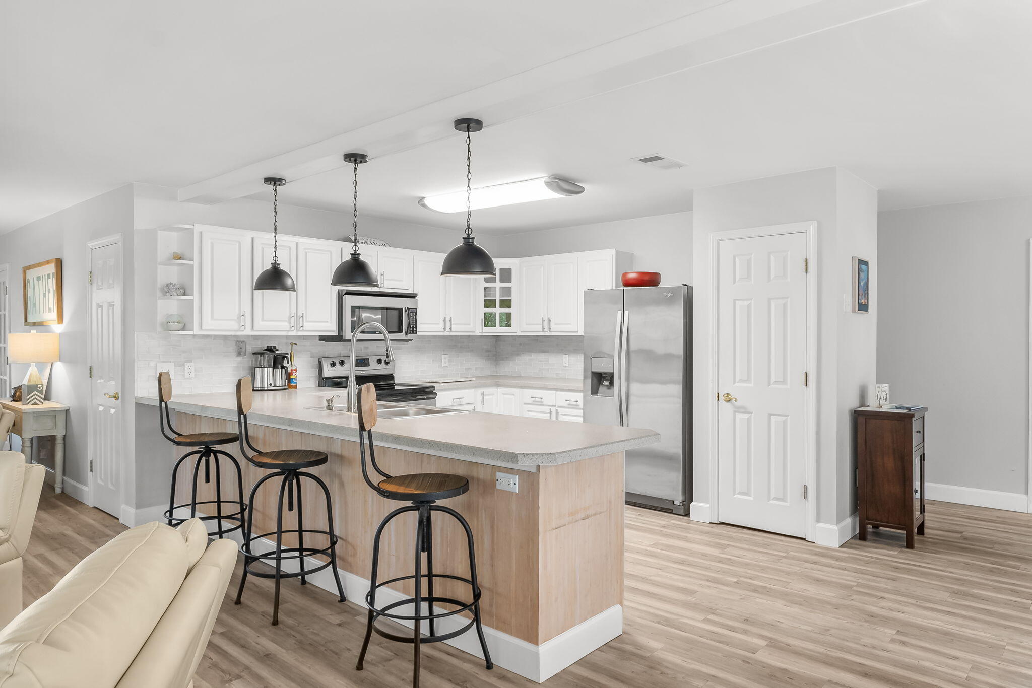 193 Portland Park Road Freeport, FL 32439 - Photo 13 of 62 a kitchen with stainless steel appliances kitchen island granite countertop a table chairs and a refrigerator