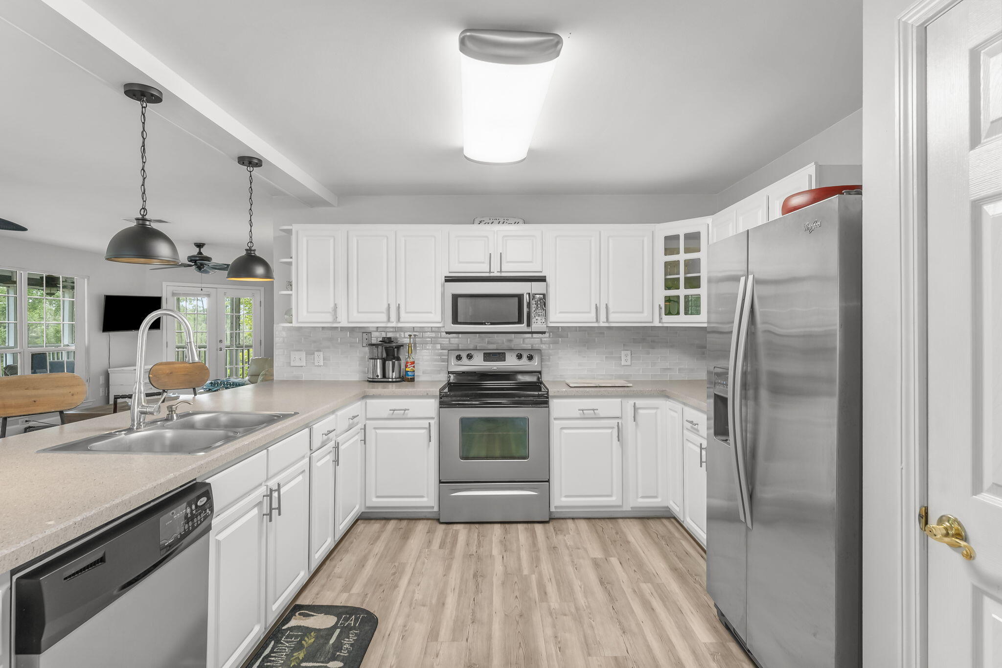 193 Portland Park Road Freeport, FL 32439 - Photo 15 of 62 a kitchen with a sink stainless steel appliances and white cabinets