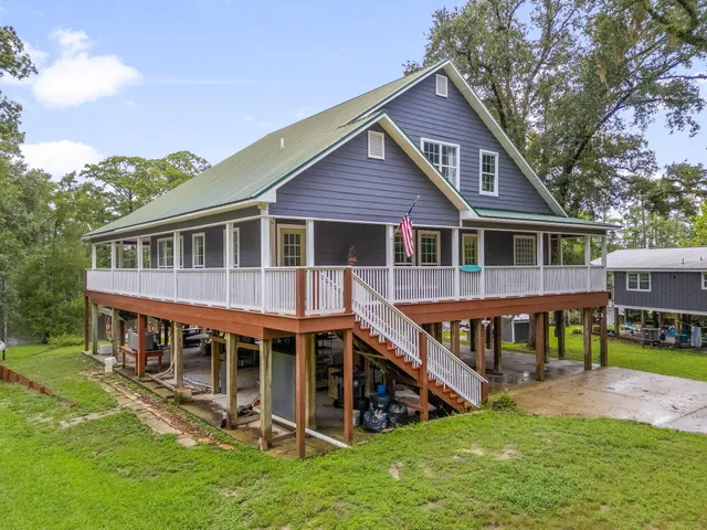 a view of a house with a yard and sitting area