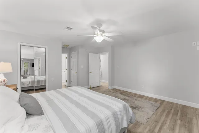 a bedroom with a large bed and a chandelier