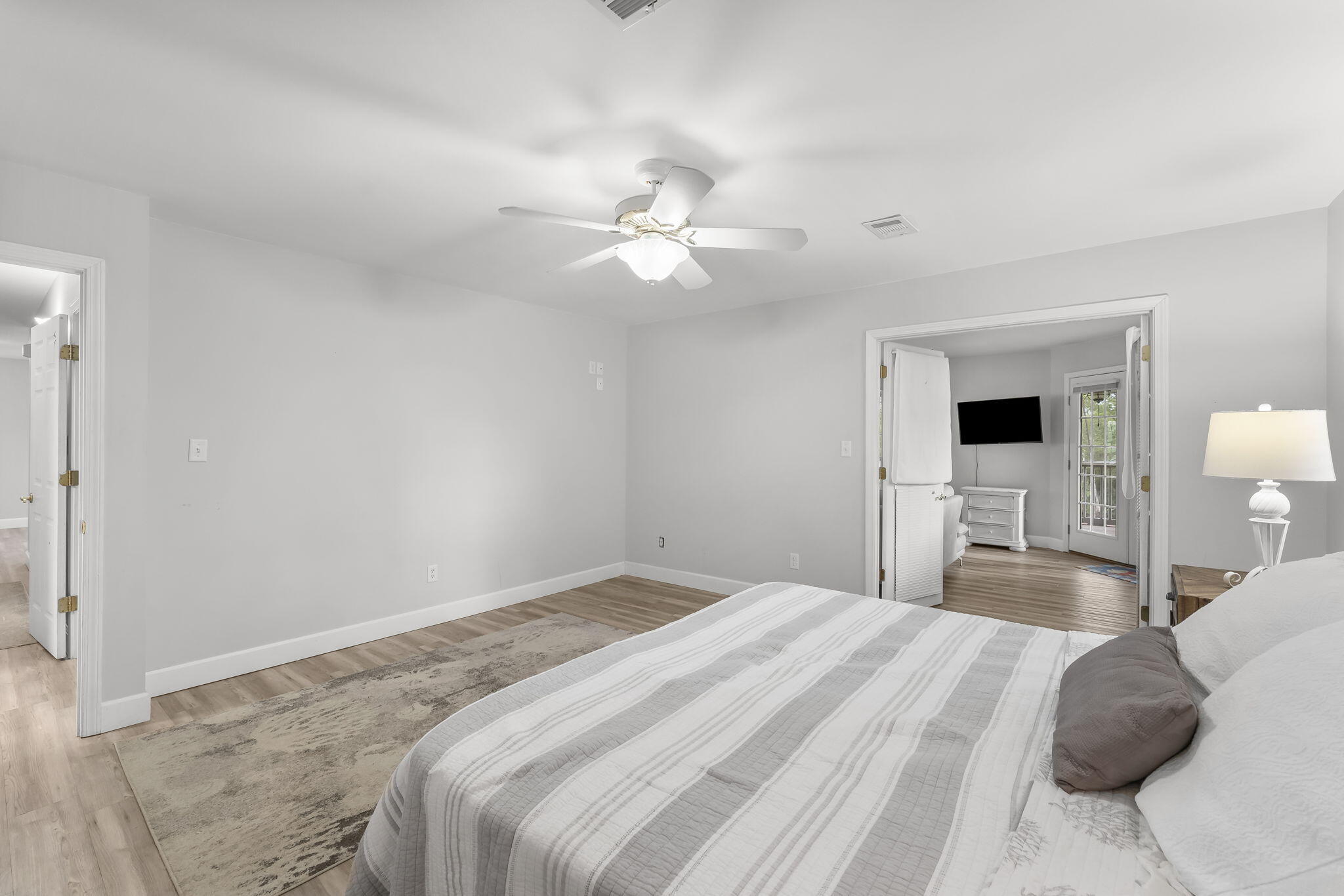 193 Portland Park Road Freeport, FL 32439 - Photo 25 of 62 a bedroom with a large bed and a chandelier