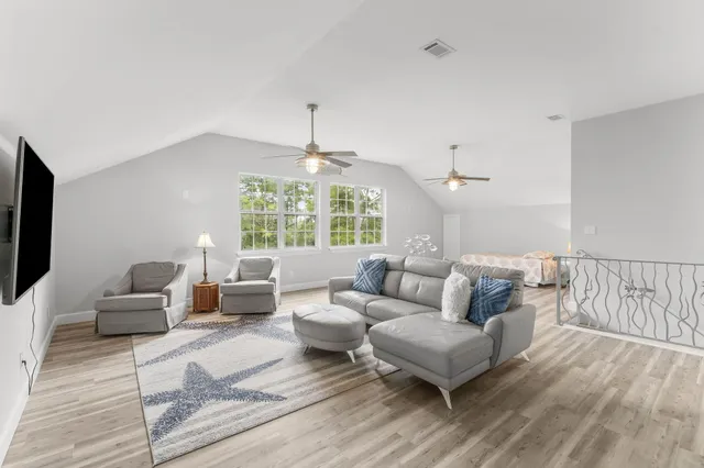 a aerial view of a house with swimming pool and lake view