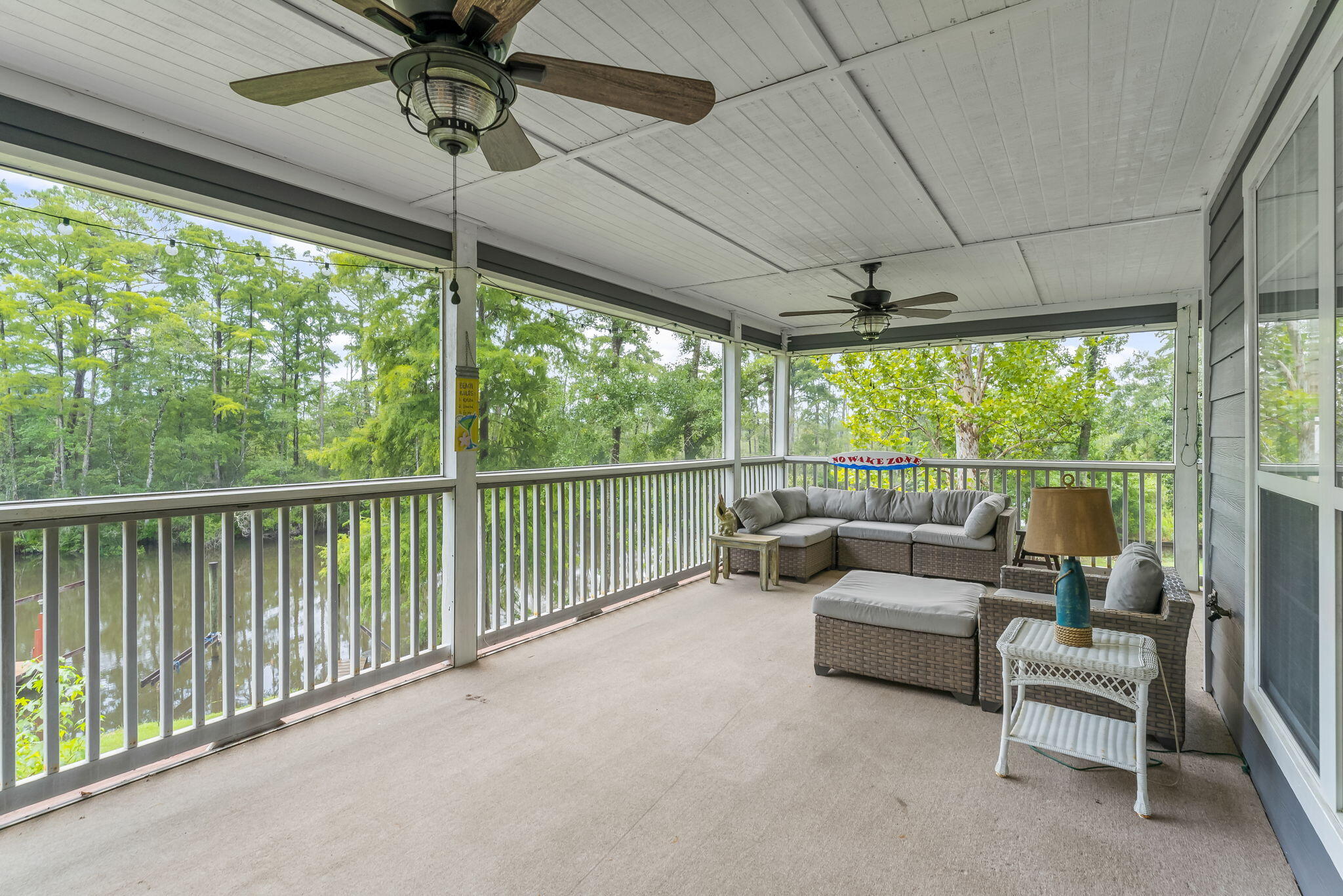 193 Portland Park Road Freeport, FL 32439 - Photo 42 of 62 a view of a patio with couches under an umbrella