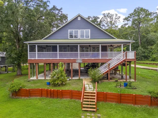 an aerial view of a house with a yard and garden