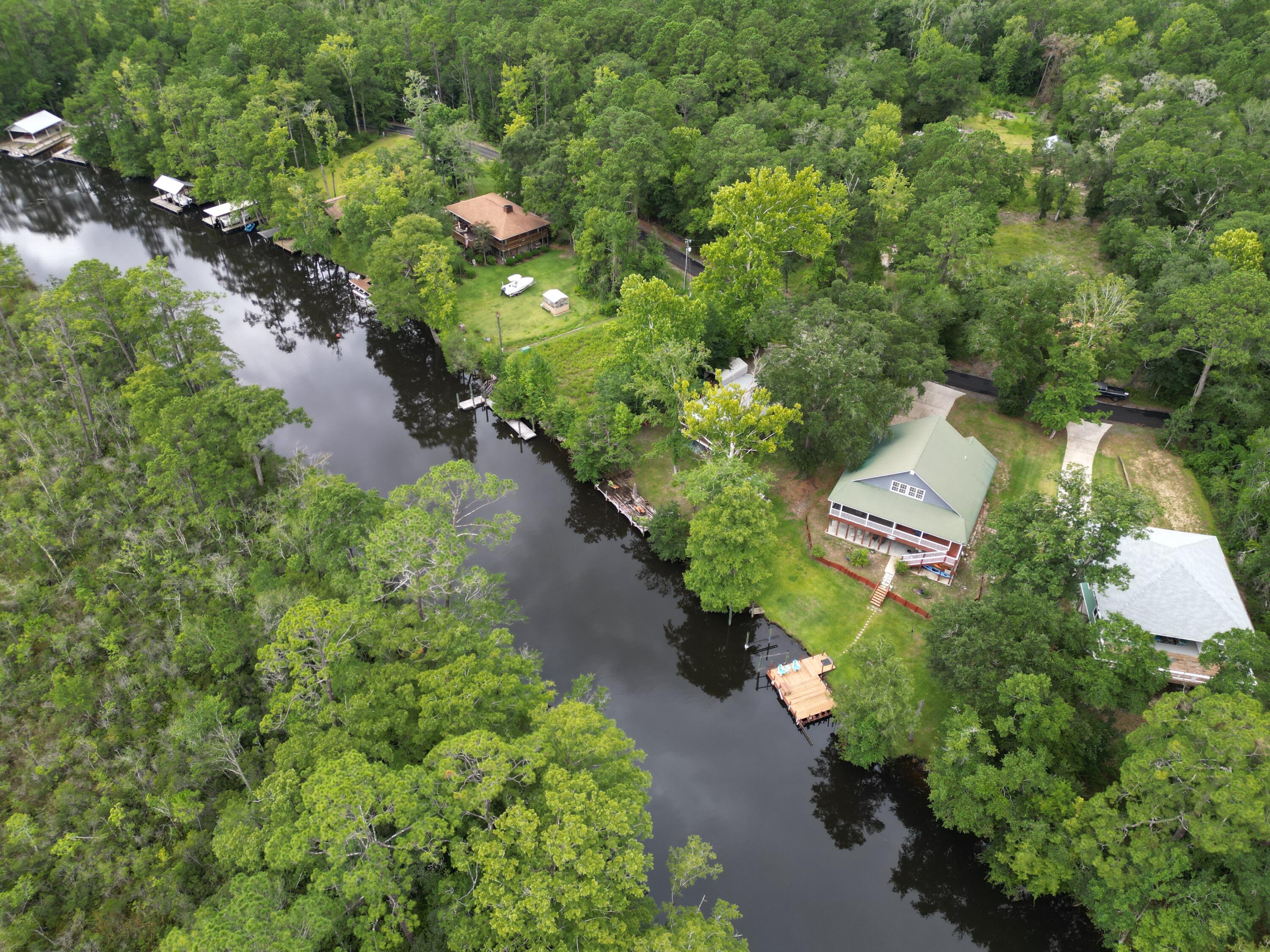 193 Portland Park Road Freeport, FL 32439 - Photo 54 of 62 an aerial view of a house with a yard and lake view