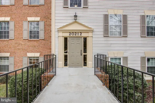 a view of a brick house with wooden stairs