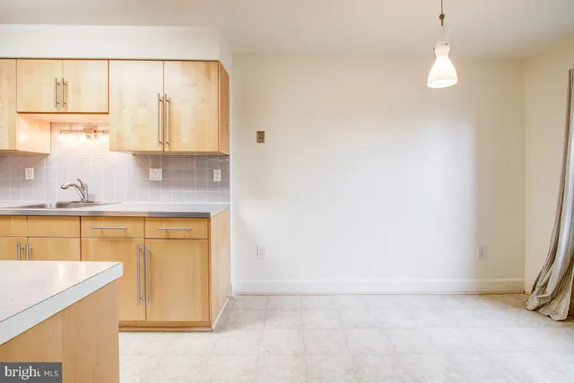 a kitchen with stainless steel appliances granite countertop a sink and a stove