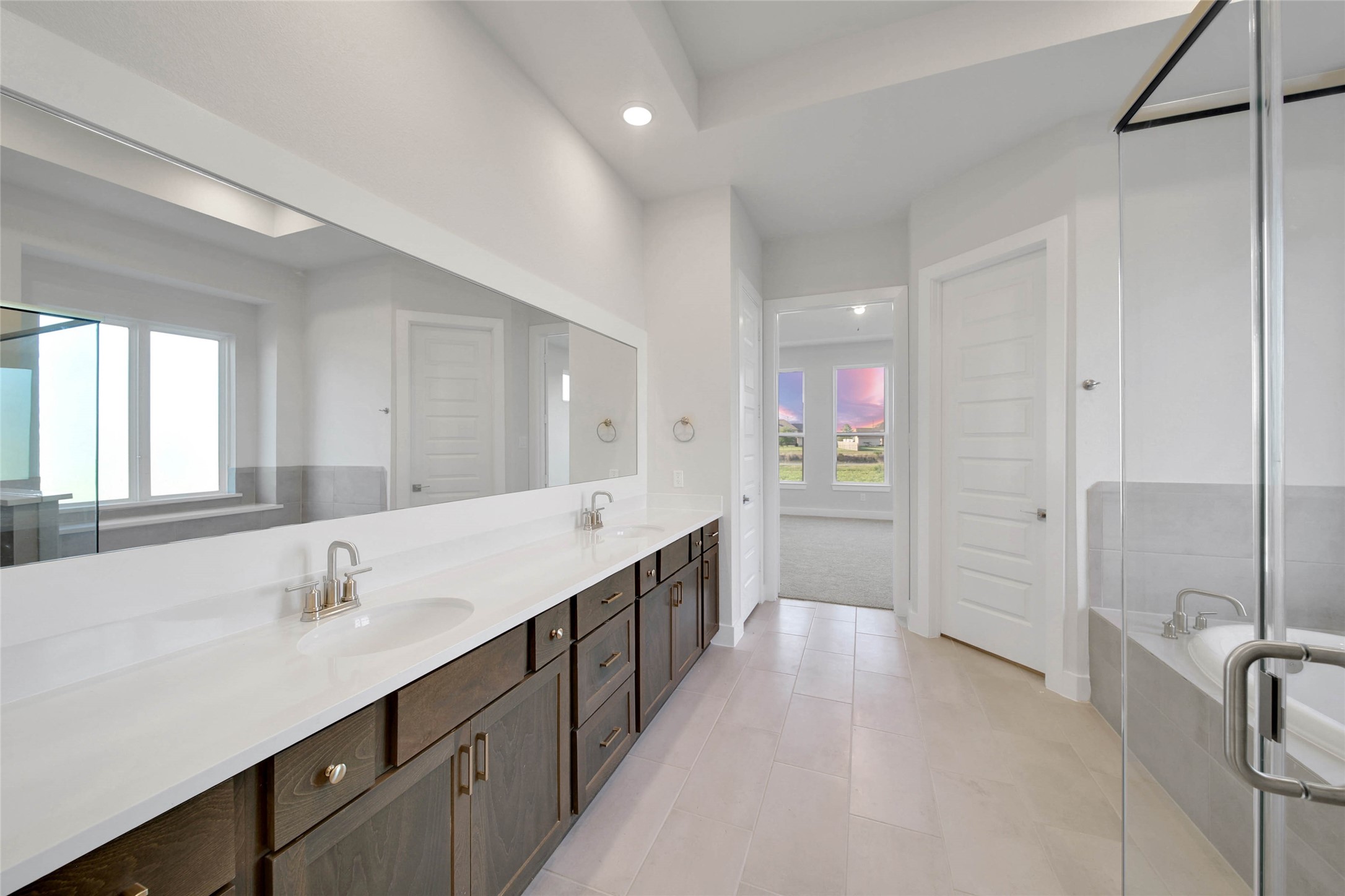 4515 Magnolia Bend Drive Rosharon, TX 77583 - Photo 19 of 46 a bathroom with a double vanity sink a mirror and a bathtub