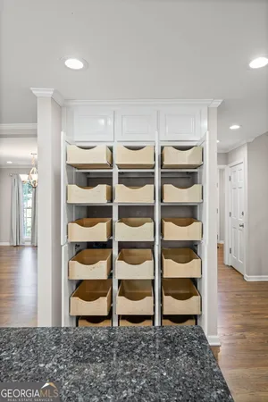 a view of kitchen with granite countertop cabinets and refrigerator
