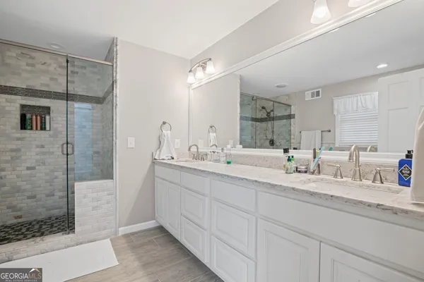 an empty room with wooden floor and window