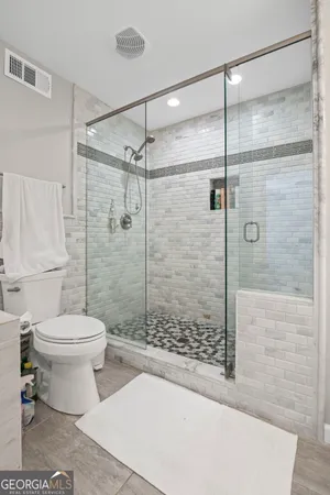 a view of a room with wooden floor and a ceiling fan