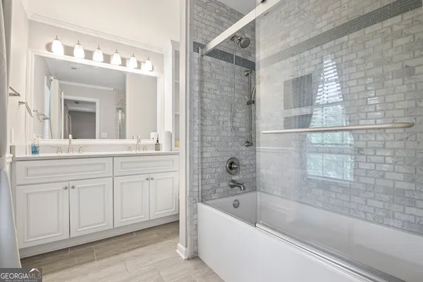 a bathroom with double vanity sinks and a granite counter top