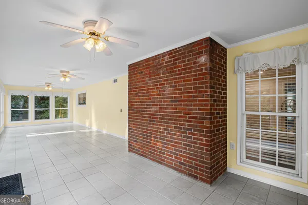 a view of an entryway with a floor to ceiling window and a ceiling fan
