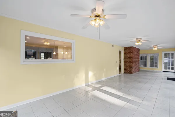 a view of a livingroom with a ceiling fan and window