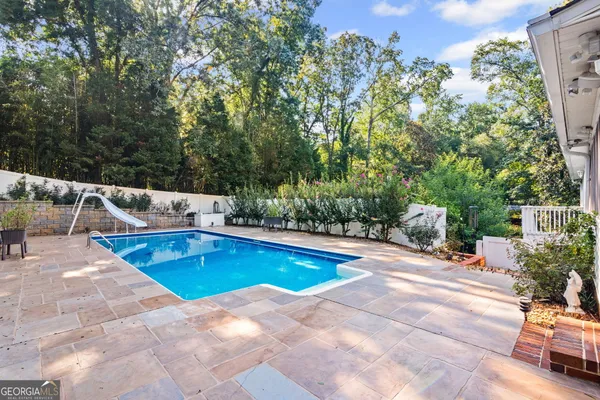 a view of a house with a yard and sitting area