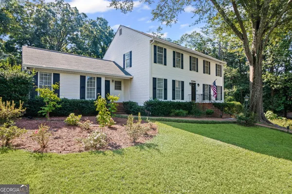 a front view of a house with a yard and porch