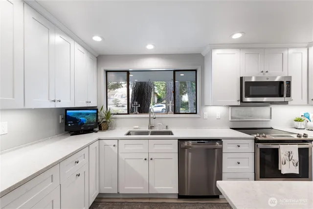 a kitchen with stainless steel appliances granite countertop a stove and a sink