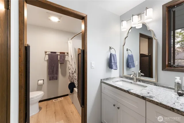 a bathroom with a double vanity sink and mirror