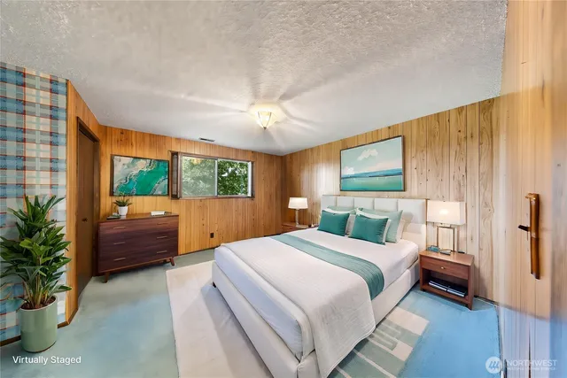 a bedroom with a balcony a bed and a chandelier