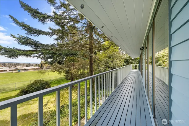 a view of balcony with wooden floor