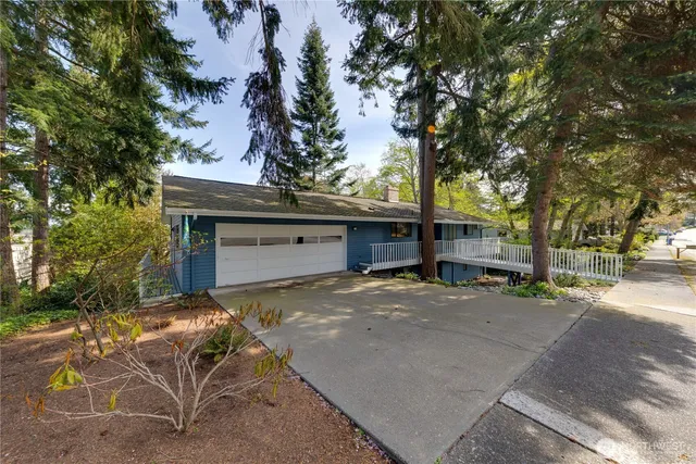 an aerial view of residential houses with outdoor space and trees