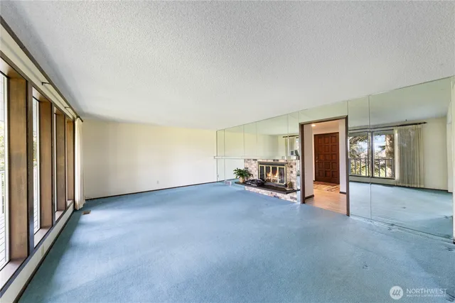 an empty room with furniture and windows