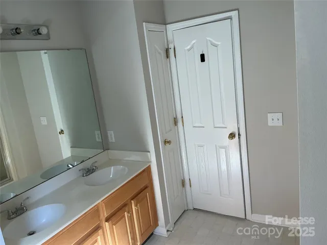 a bathroom with a granite countertop sink mirror and shower