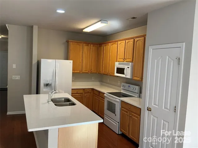 a kitchen with a stove and a refrigerator