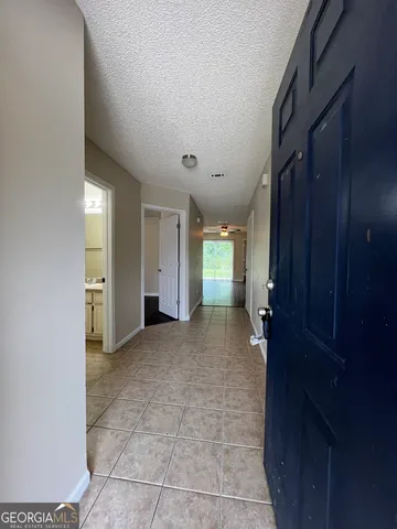 a view of a hallway with wooden shelves