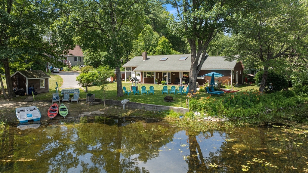a view of a house with swimming pool and chairs
