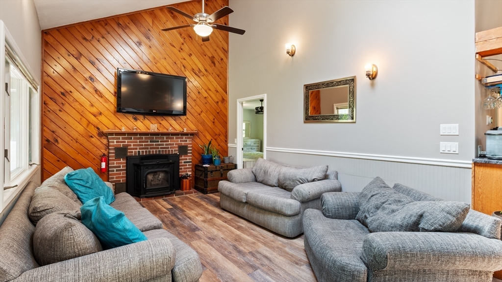 16 Sandy Cove Road Lunenburg, MA 01462 - Photo 11 of 38 a living room with furniture a flat screen tv and a fireplace