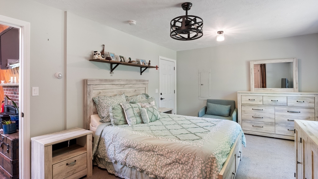 16 Sandy Cove Road Lunenburg, MA 01462 - Photo 25 of 38 a bedroom with a bed and a chandelier