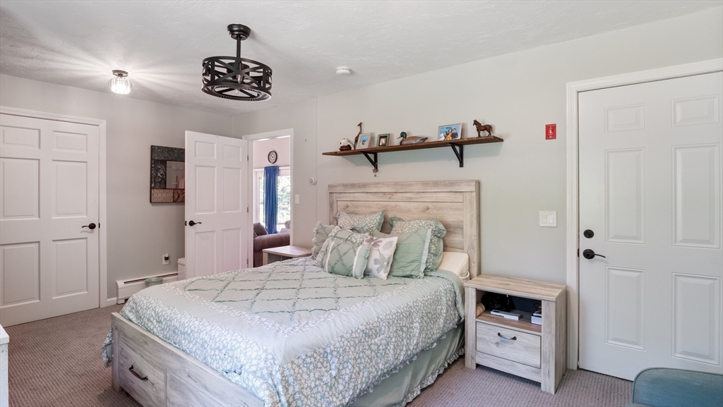 16 Sandy Cove Road Lunenburg, MA 01462 - Photo 26 of 38 a bedroom with a bed and a chandelier