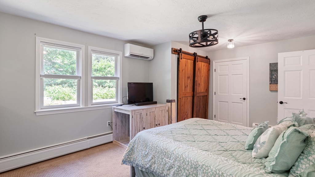 16 Sandy Cove Road Lunenburg, MA 01462 - Photo 27 of 38 a bedroom with a bed and a flat screen tv
