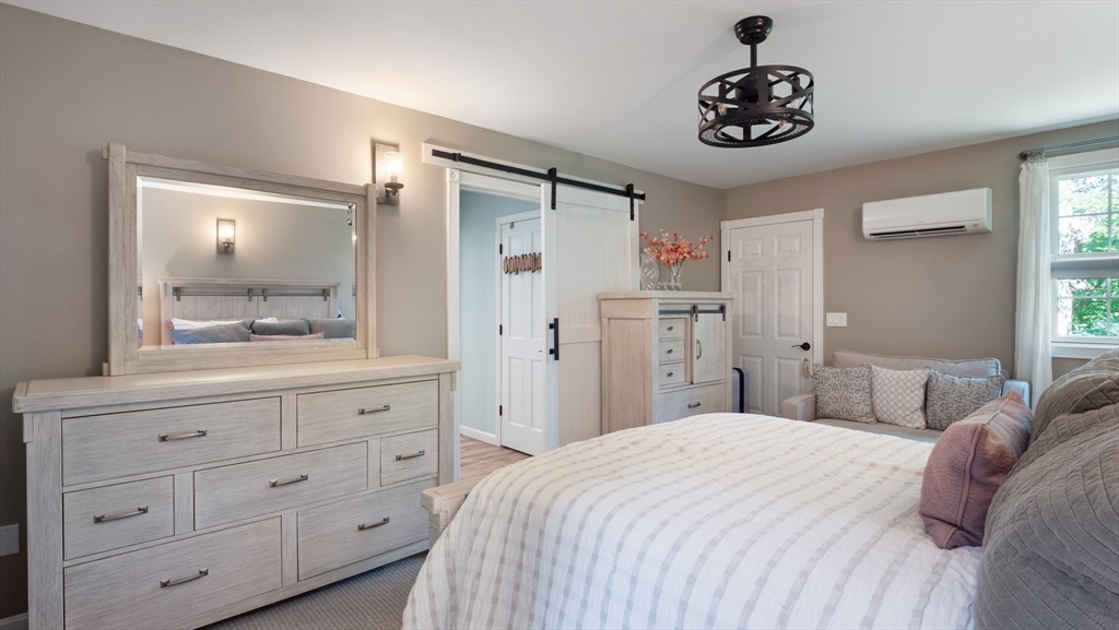 16 Sandy Cove Road Lunenburg, MA 01462 - Photo 29 of 38 a bedroom with a large bed and a mirror