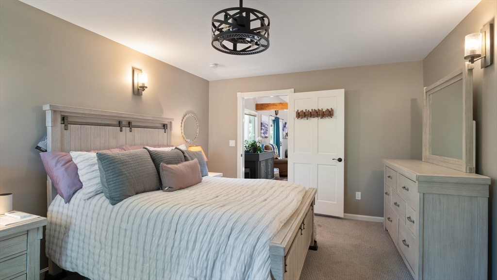 16 Sandy Cove Road Lunenburg, MA 01462 - Photo 31 of 38 a bedroom with a bed and a chandelier