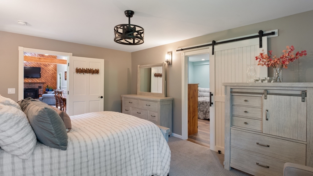 16 Sandy Cove Road Lunenburg, MA 01462 - Photo 32 of 38 a bedroom with a bed and a chandelier
